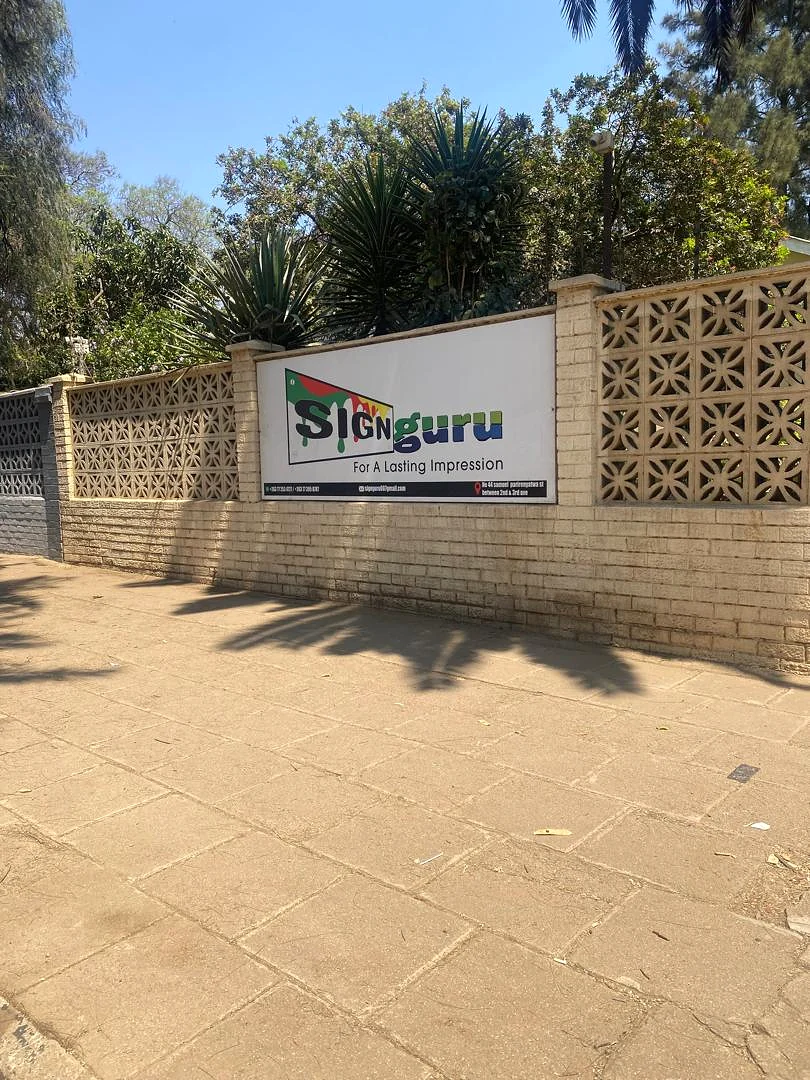 Sign Guru office frontage sign reading For A Lasting Impression on a Bulawayo street wall